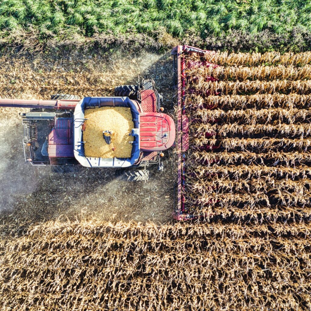 Tractor Harvesting Crops on Agricultural Farmland